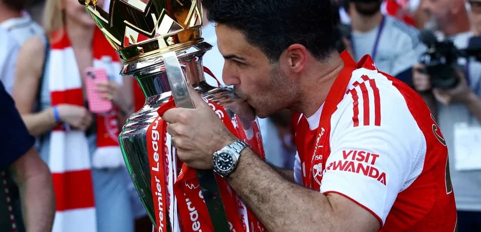 Manager kissing Premier League trophy during celebration