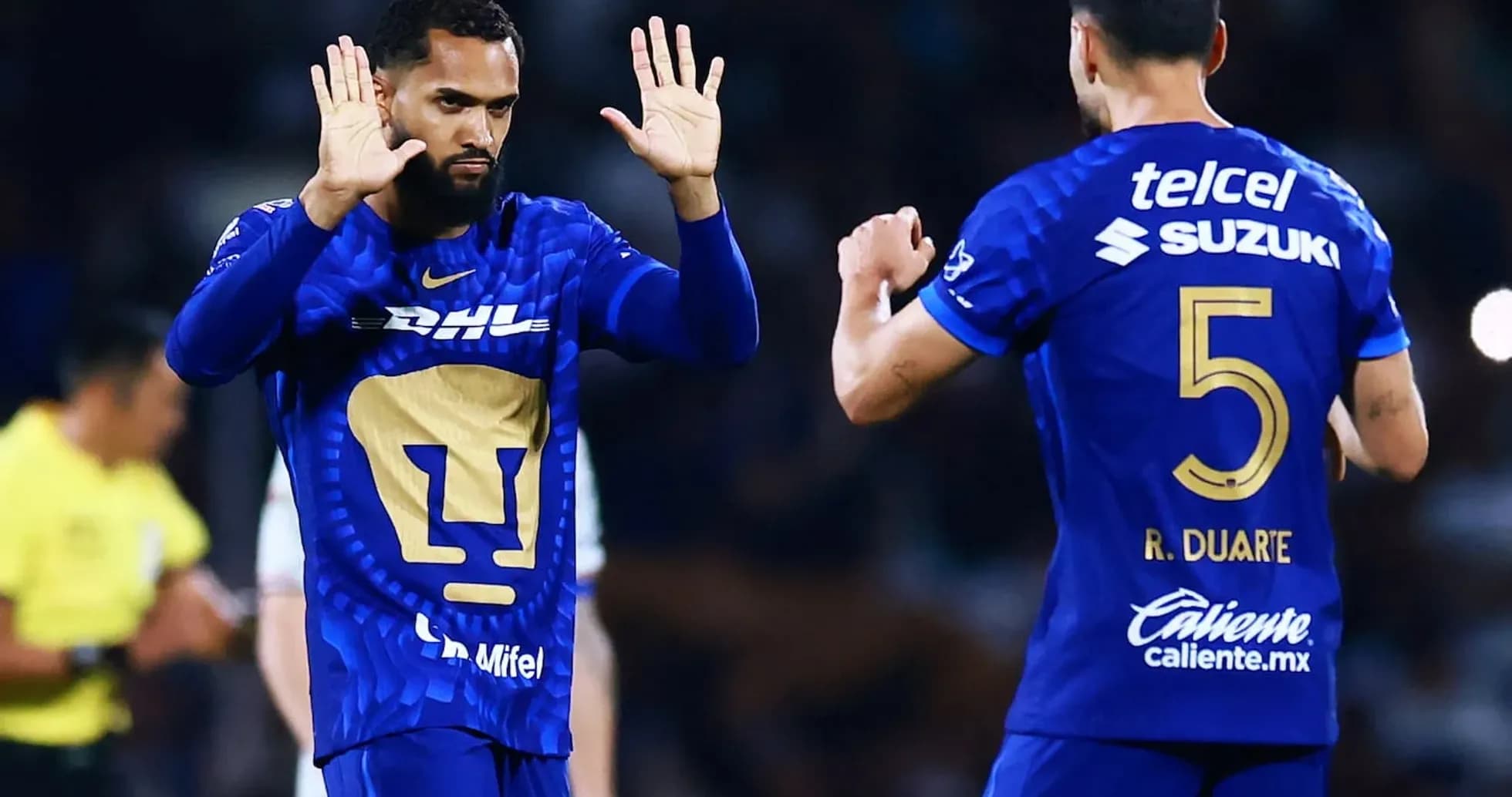 Pumas players celebrating during Liga MX match