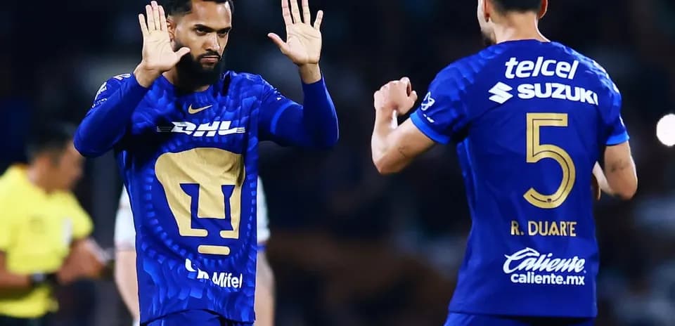 Pumas players celebrating during Liga MX match