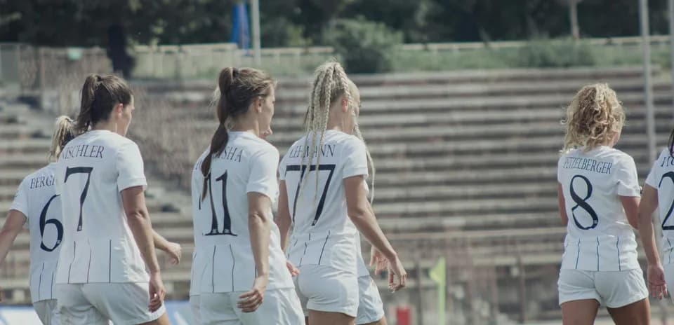 Women players walking on the football field