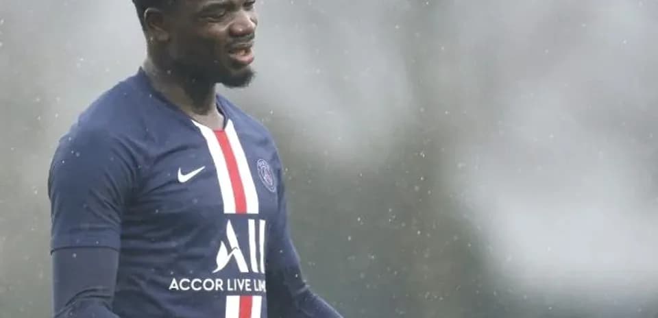 Player gesturing during training session in rain