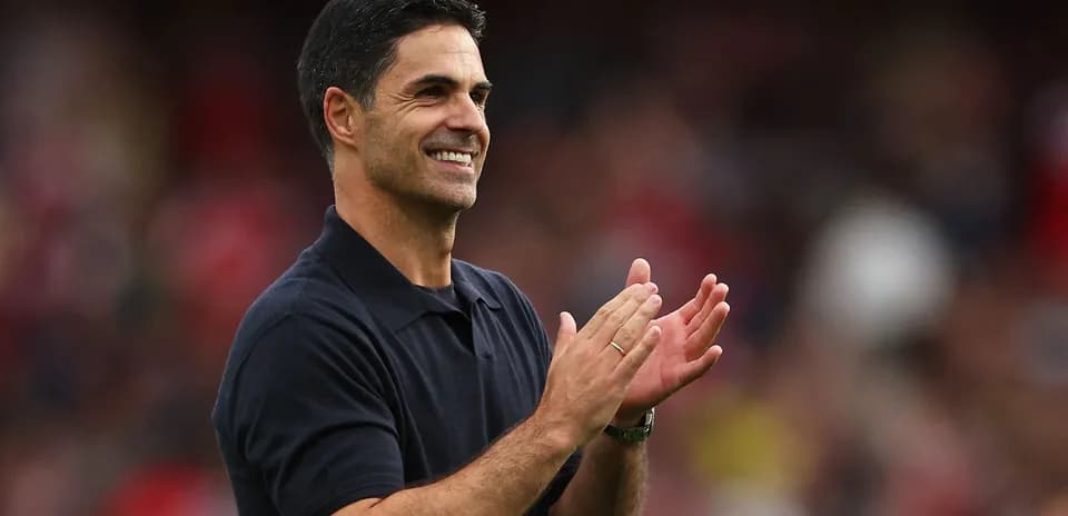 Coach applauding during a match at the stadium