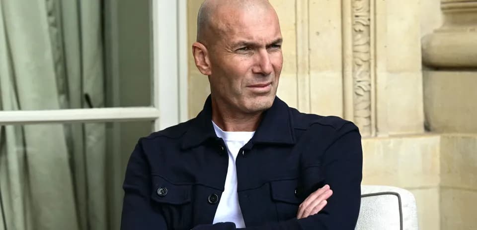 Man sitting with arms crossed in casual attire