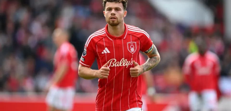 Player in red jersey walking on the field