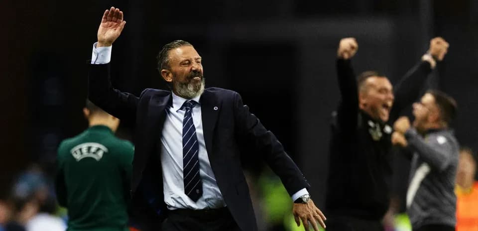 Coach celebrating with staff during match victory