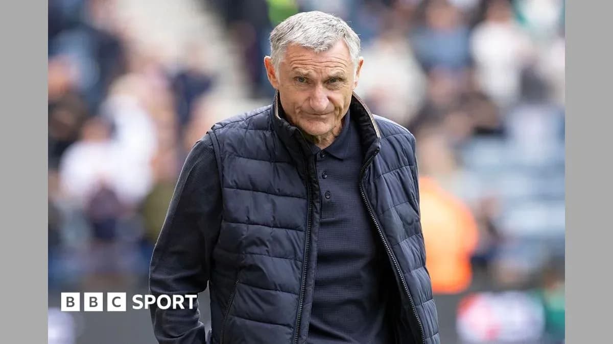 Manager walking on the pitch during a match