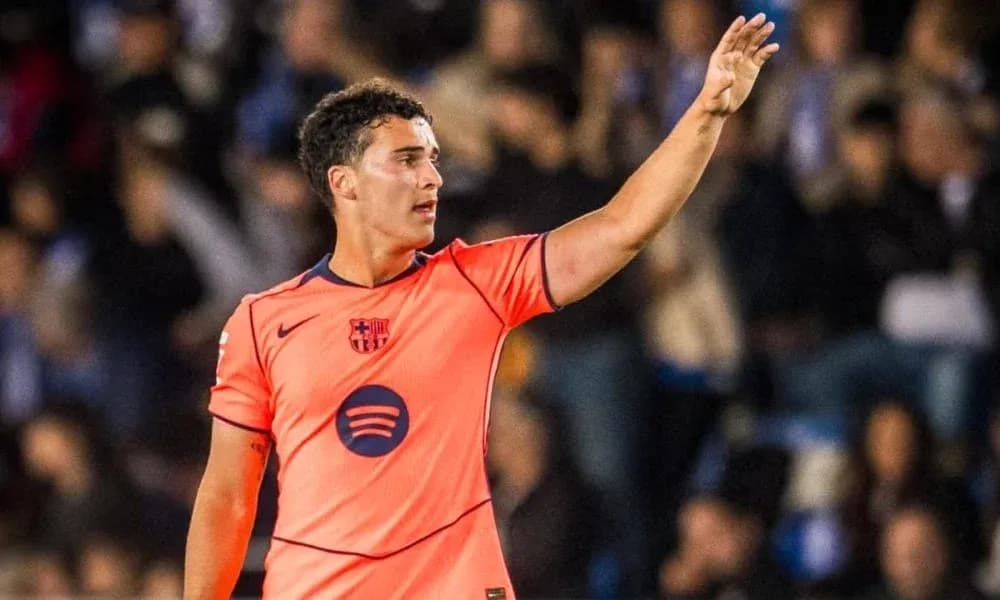 Player in orange jersey signaling during match