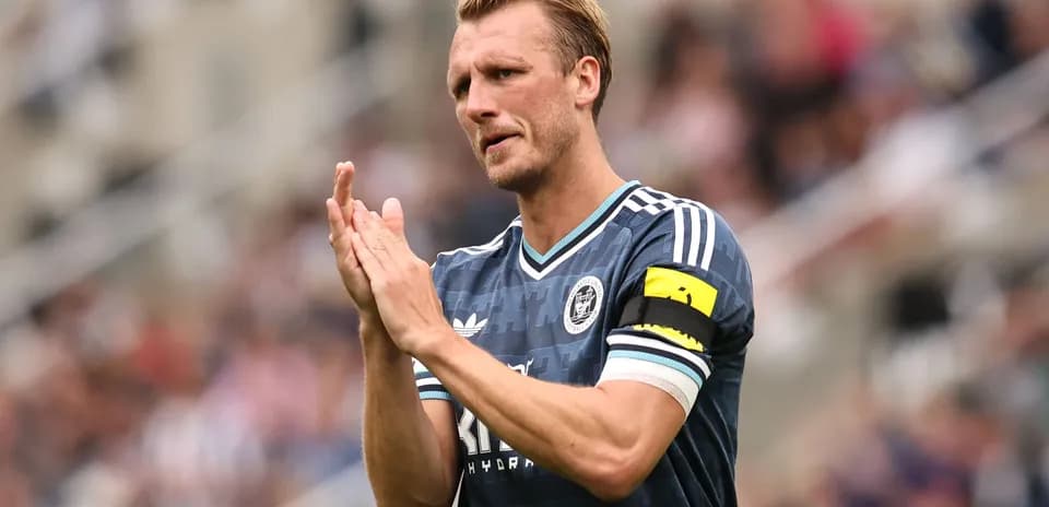 Player applauding fans wearing team jersey