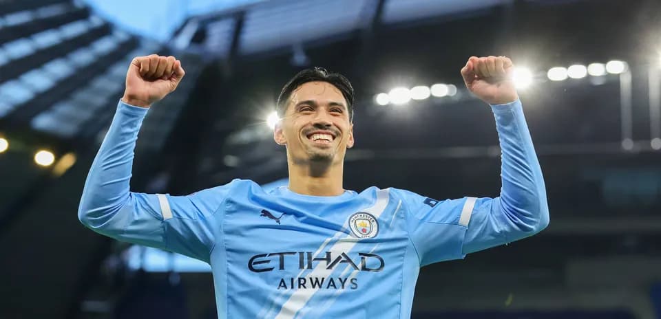 Player celebrating victory in Manchester City jersey