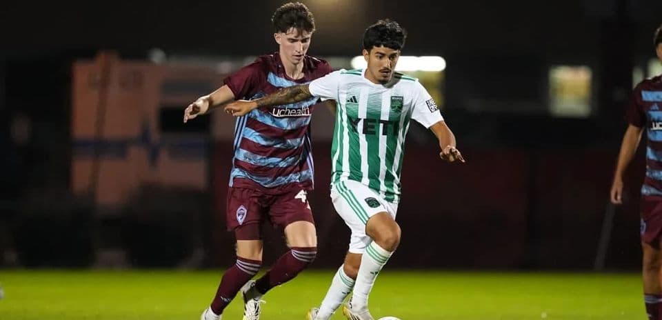 Players competing for the ball in MLS Next Pro