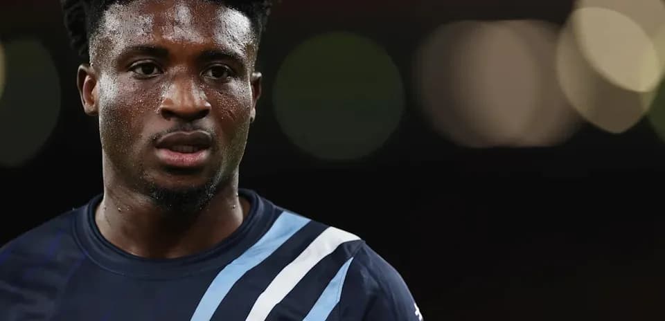 Player in dark jersey with focused expression