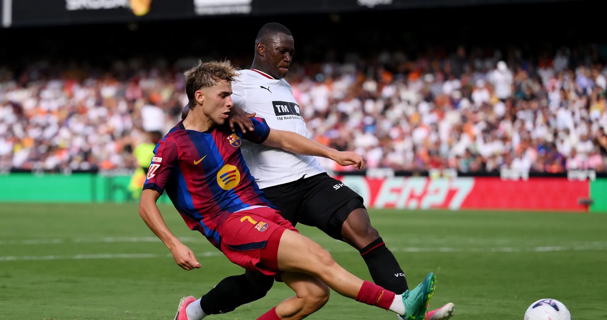 Barcelona player challenged by opponent during match