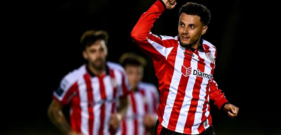 Player celebrating goal with teammates in background