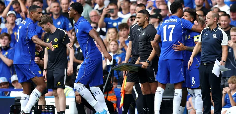 Players exchanging greetings during match substitutions