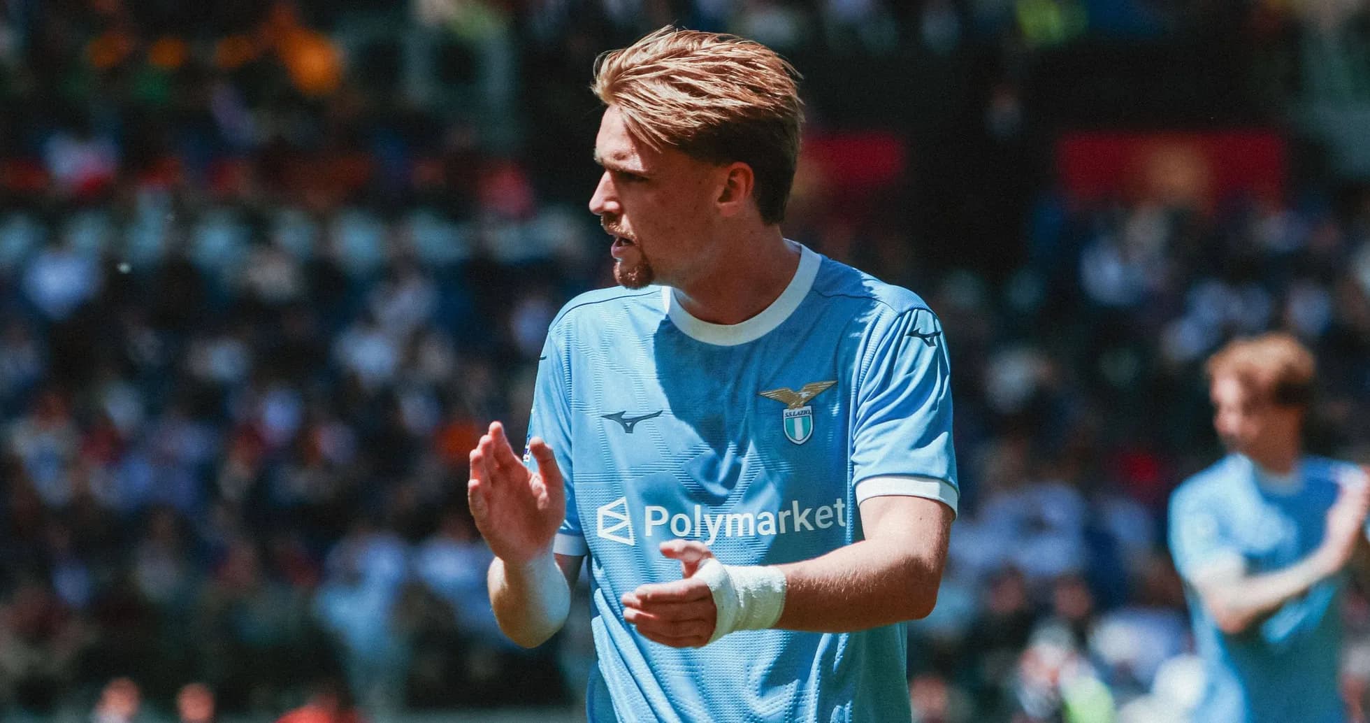 Lazio player applauding fans during a match