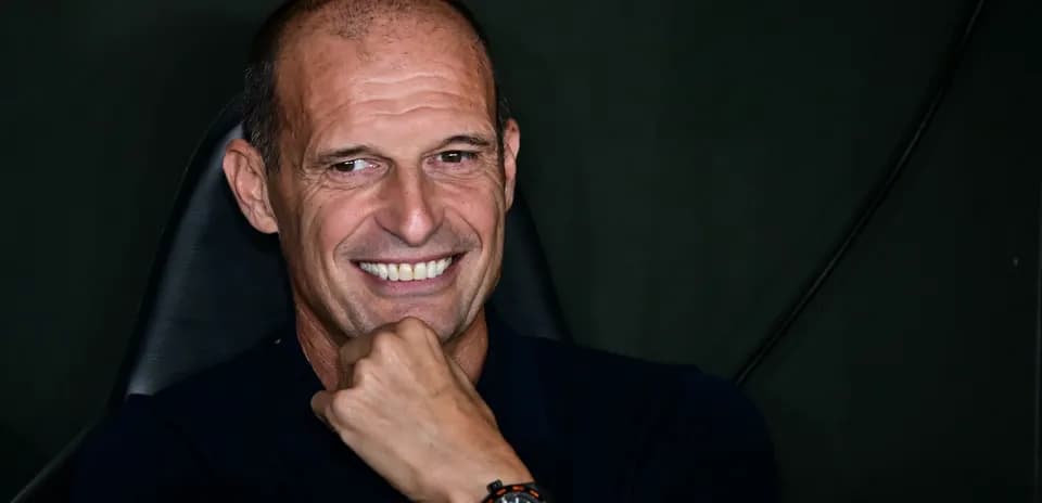 Man smiling while resting chin on hand