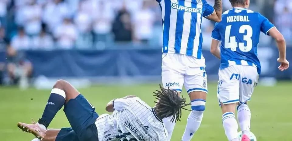 Lech Poznan player avoiding a tackle during match