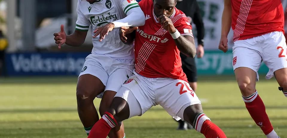 Two players battling for the ball in match