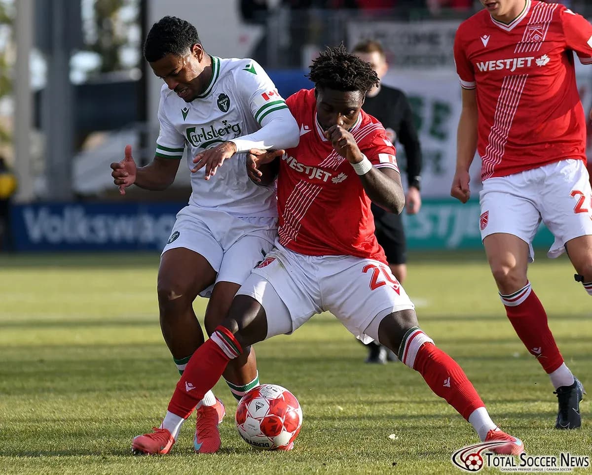 Two players battling for the ball in match