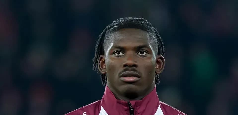Player in maroon jacket looking ahead during match
