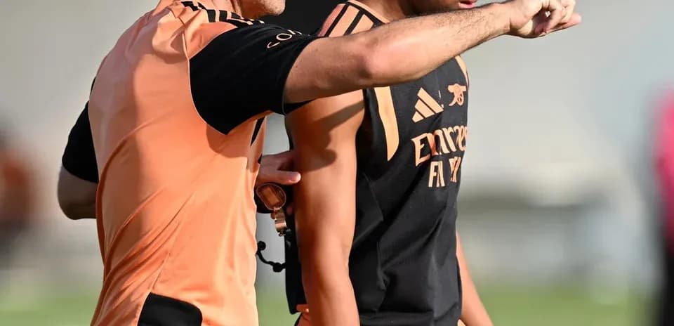 Coach instructing player during training session