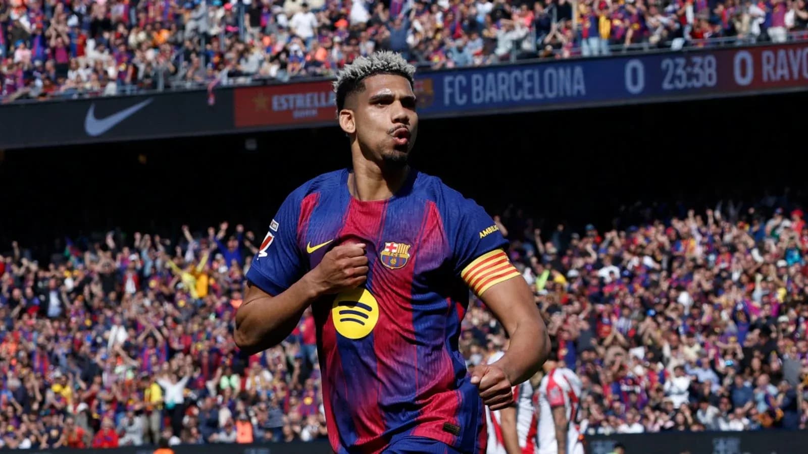 Player celebrating a goal at Barcelona stadium