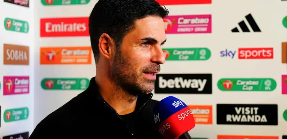 Manager speaking during press conference with sponsors backdrop