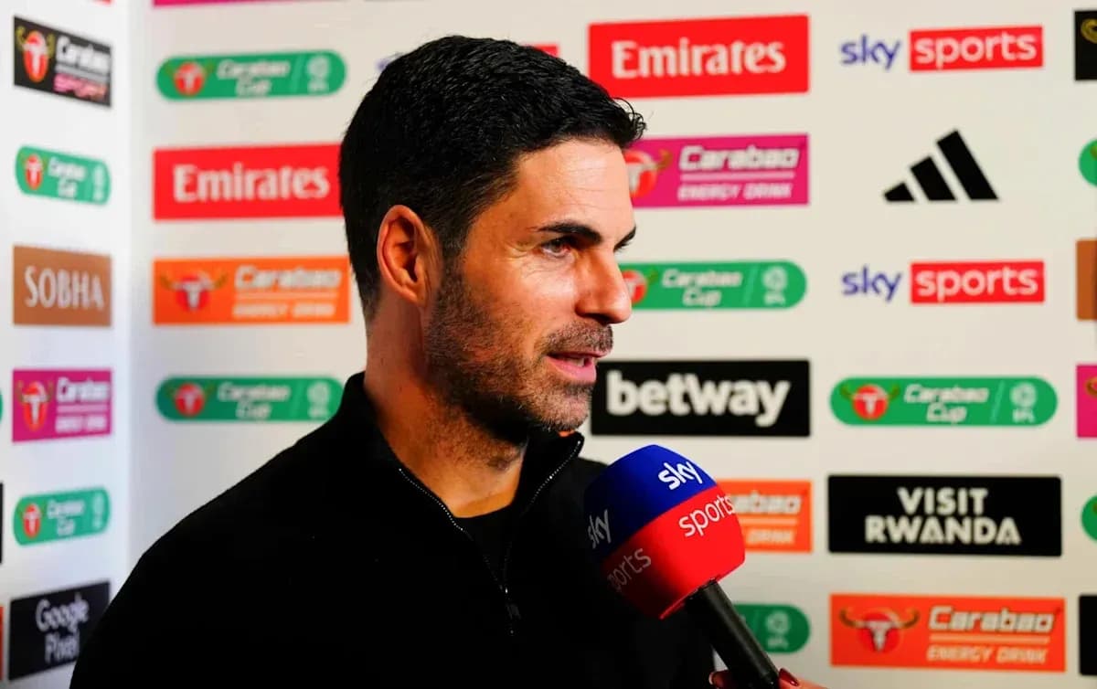Manager speaking during press conference with sponsors backdrop
