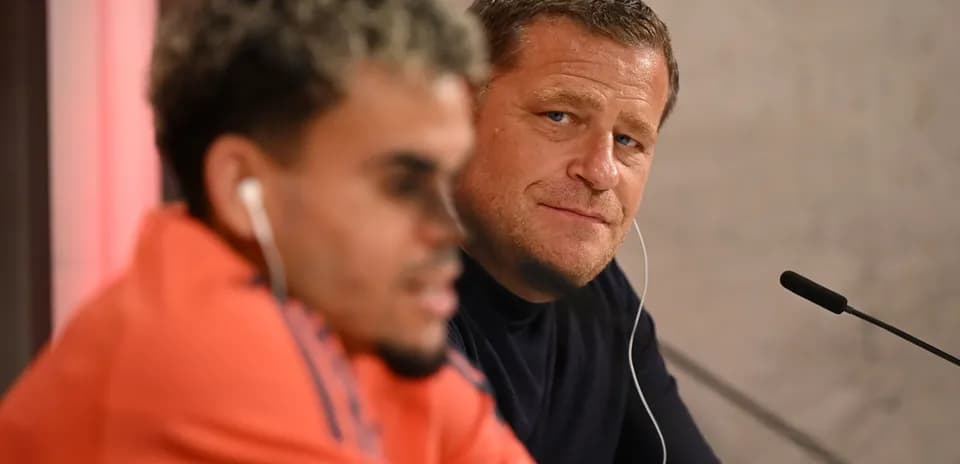 Two men at a press conference with microphones