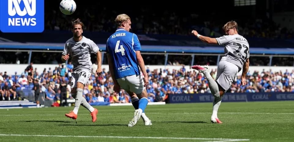 Player striking the ball during a football match