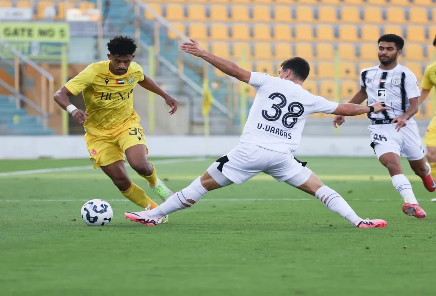 Al Wasl U23 player evading tackle from Al Jazira U23