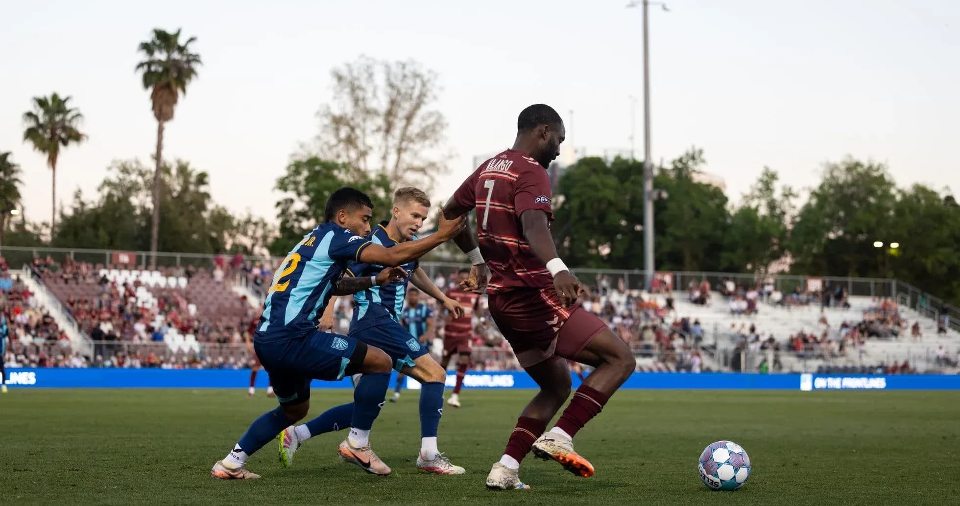 Two players competing for the ball in football match