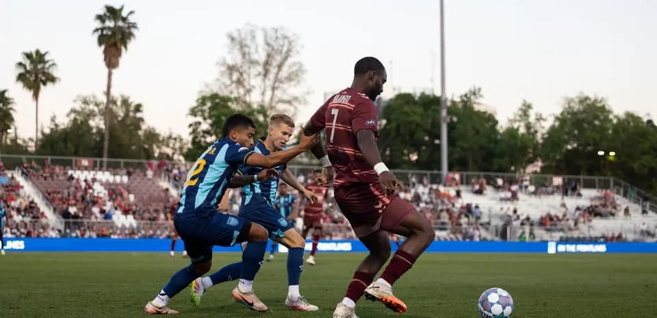 Two players competing for the ball in football match