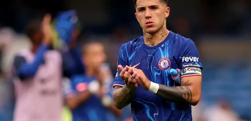 Player applauding fans wearing Chelsea jersey