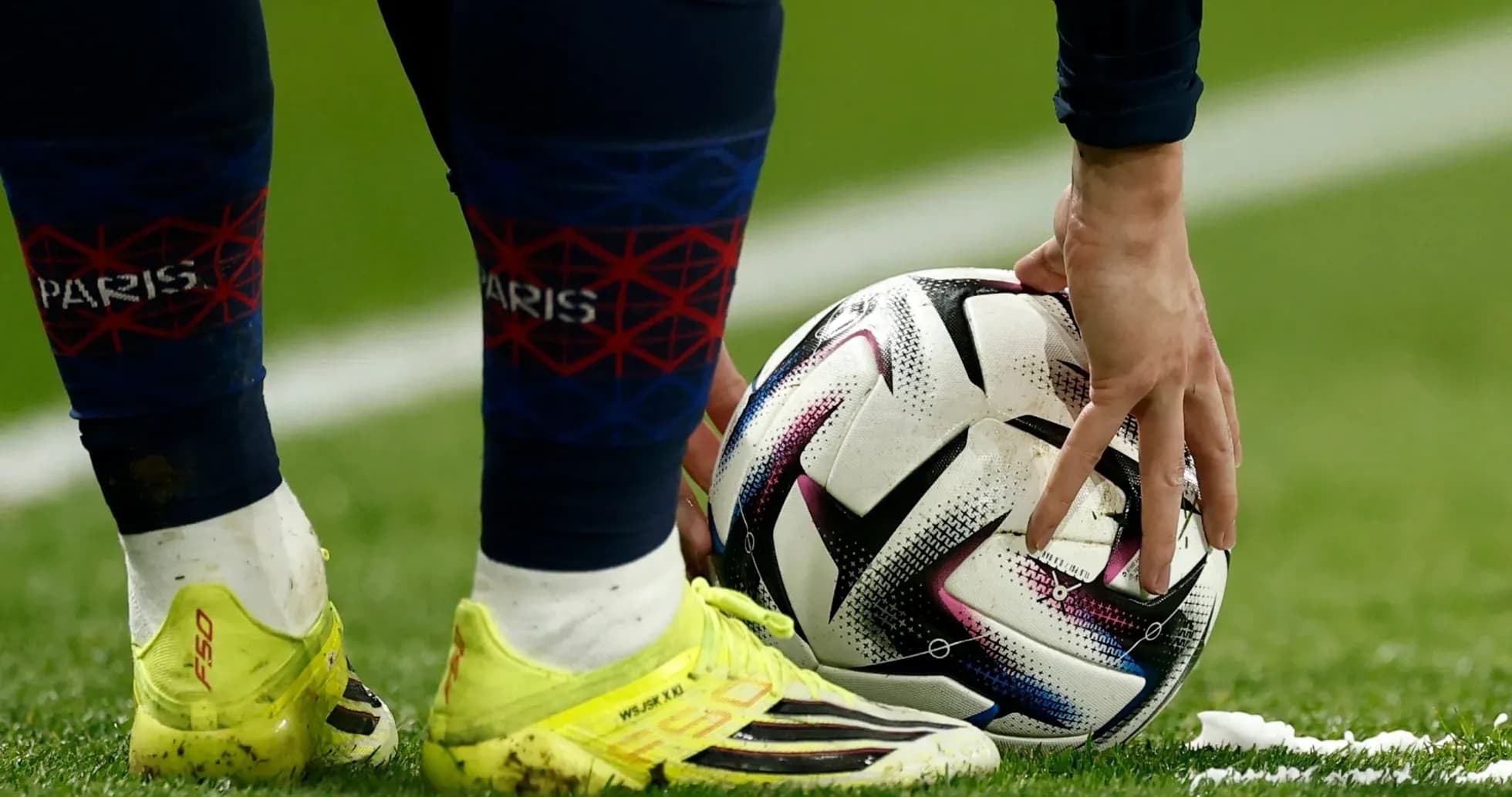 Player placing ball for set piece on pitch