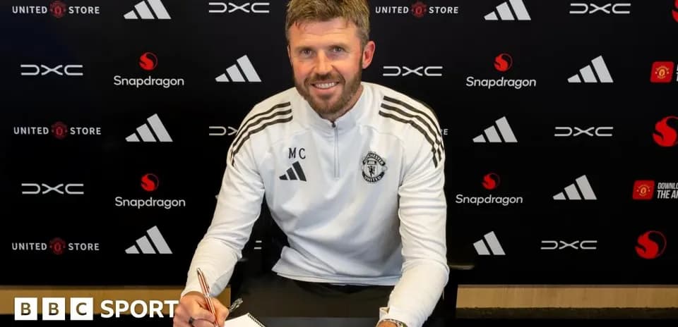 Coach signing contract at Manchester United office
