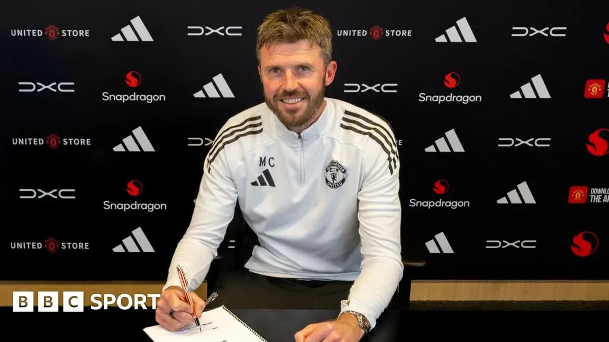 Coach signing contract at Manchester United office