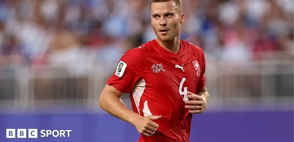 Player wearing red Swiss national team jersey on field