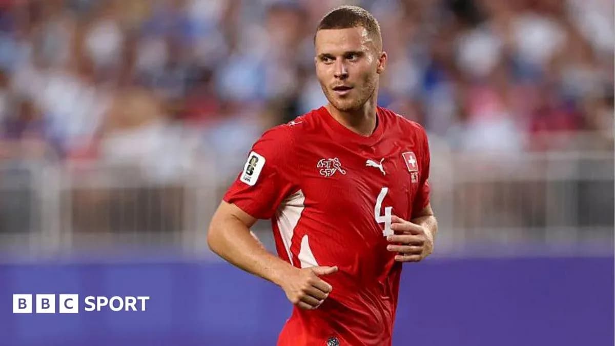 Player wearing red Swiss national team jersey on field