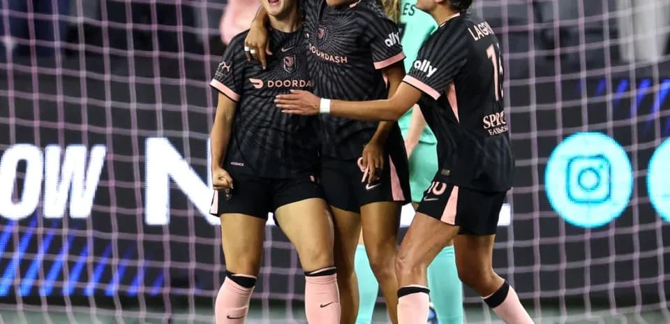 Players celebrating a goal during NWSL match