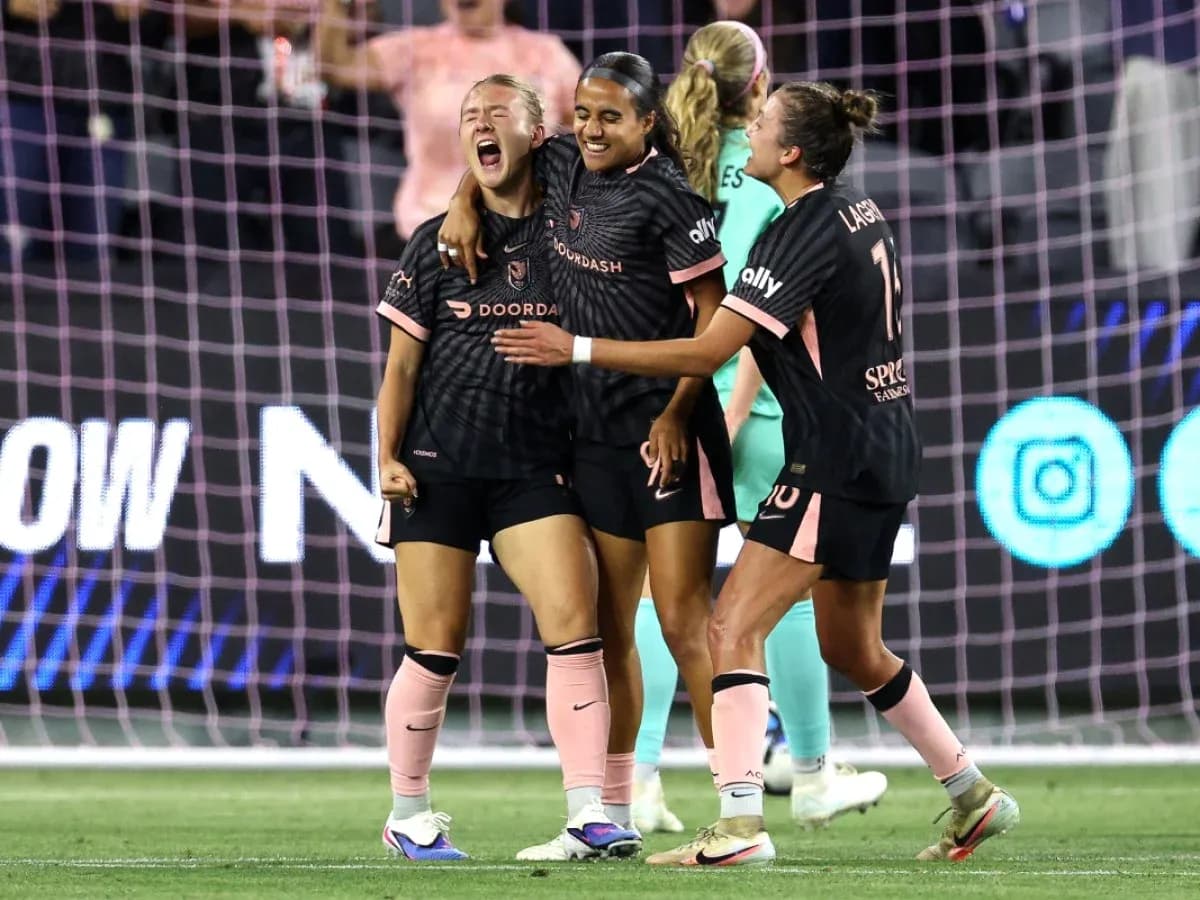 Players celebrating a goal during NWSL match