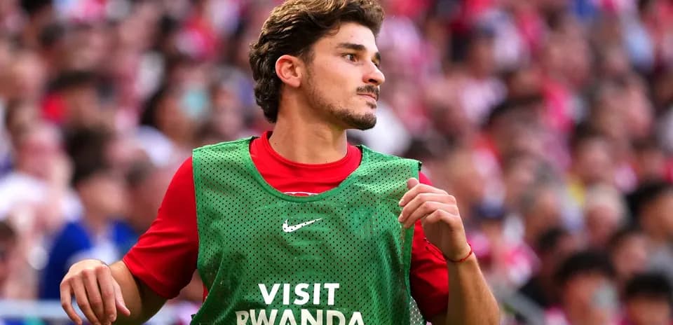 Player in warm-up vest on sidelines during match