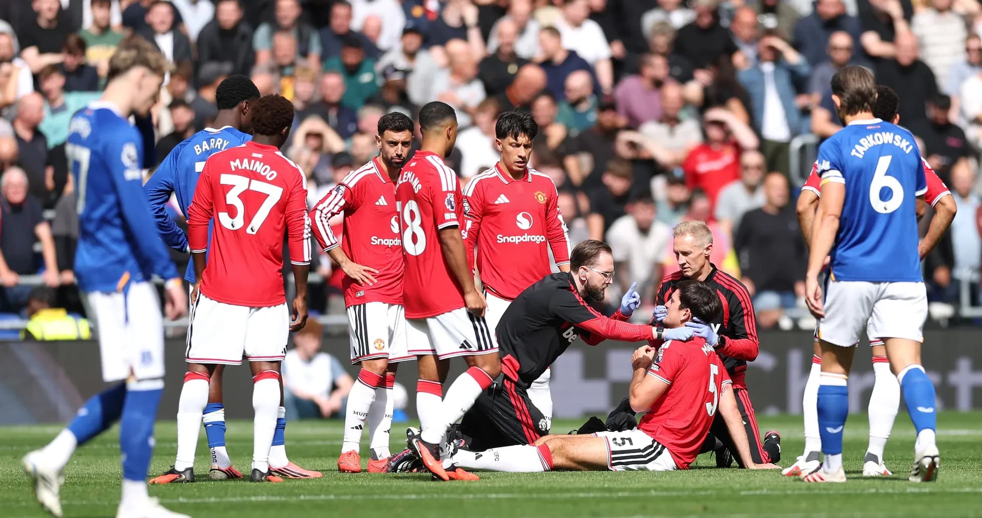 Medical staff attending to injured player on field