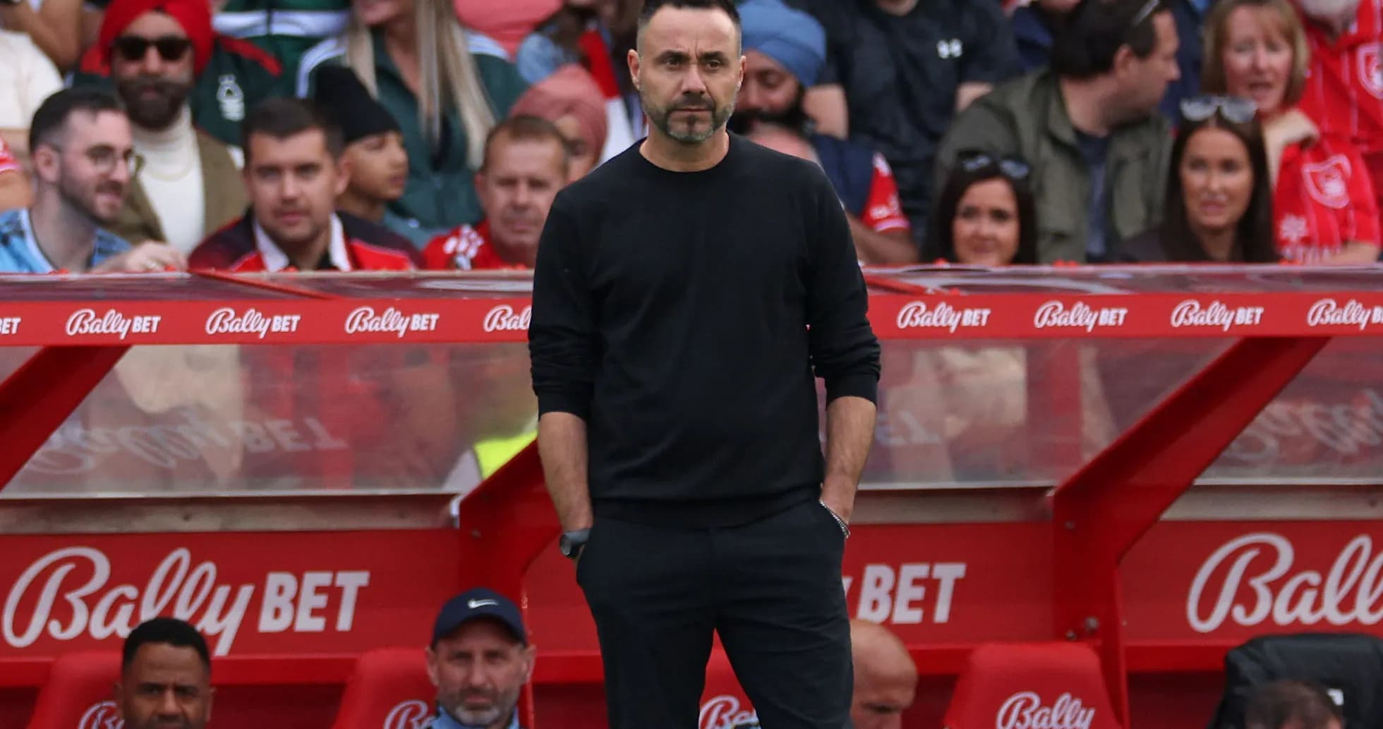 Coach standing on sidelines during a match