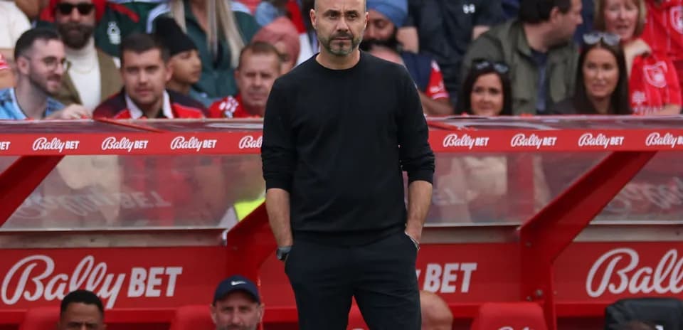 Coach standing on sidelines during a match