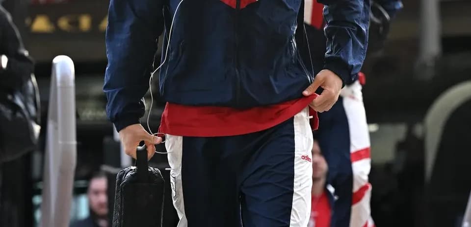 Player in team tracksuit arriving at venue