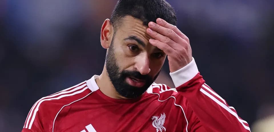 Player in red jersey touching his forehead