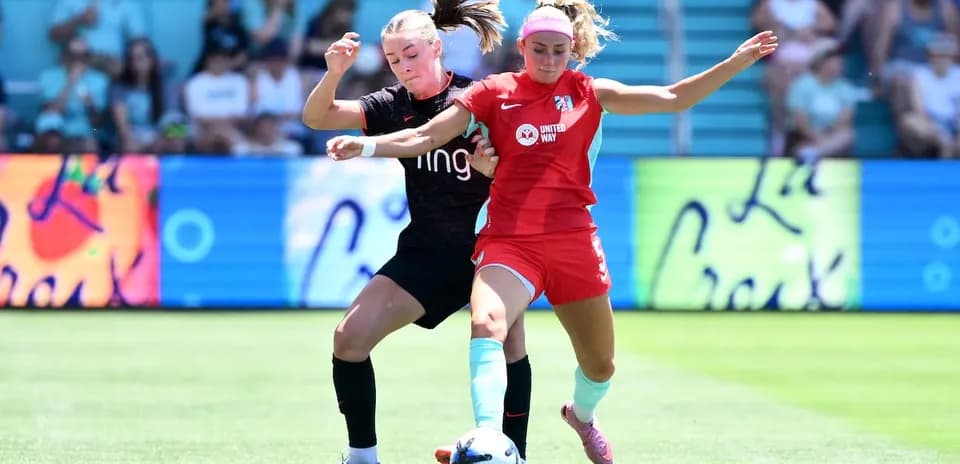 Two players competing for the ball in match