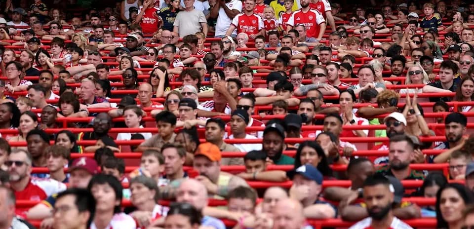 Crowd of fans in Arsenal jerseys at stadium