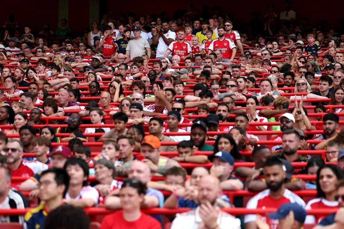 Crowd of fans in Arsenal jerseys at stadium